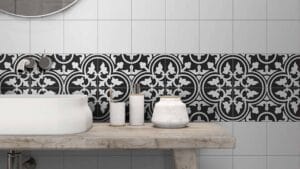 Bright modern bathroom with black and white patterned tiles, white bathtub, and minimalist accessories, showcasing stylish bathroom tile design and high-quality fixtures for contemporary interiors.