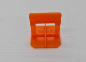 Orange plastic cable clip for organizing electrical wires and cables, easy to install and reuse, ideal for home improvement and building supplies.