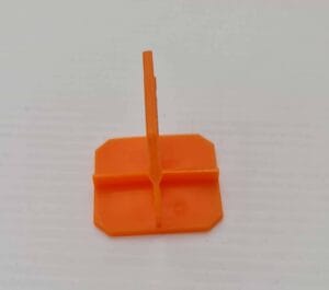 Orange plastic drywall corner bead tool for wall finishing and installation, essential for professional and DIY construction projects.