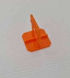 Miniature orange plastic safety barrier for construction site or hazard marking, ideal for construction and renovation projects.