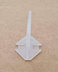 White plastic mounting clip for drywall shelving or wall mounting, durable and easy to install, ideal for home improvement and construction projects. Perfect for secure, hidden support.