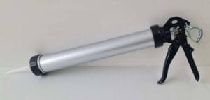 Pistol grip caulking gun with metal barrel and ergonomic handle for construction and DIY home improvement projects.