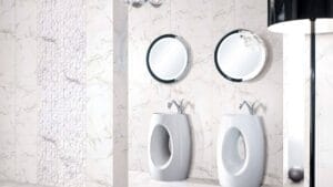 Sleek modern bathroom with two white bidets, circular illuminated mirrors, and stylish tiled walls showcasing contemporary bathroom fixtures and decor.