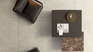 Sleek modern tile flooring in neutral tones with a stylish dark wood coffee table and decorative accessories. Perfect for contemporary home interiors and renovation projects.