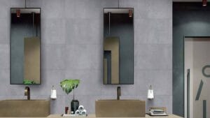 Sleek modern bathroom with large grey tiles, minimalist beige sinks, and stylish rectangular mirrors adding contemporary appeal. Perfect for interior design projects by Builders Warehouse Online.