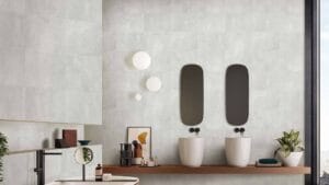 Modern bathroom interior with double sinks, oval mirrors, decorative plants, and minimalist decor, featuring neutral tones and contemporary design elements, perfect for stylish home renovation.
