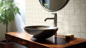 Sleek modern bathroom sink with a polished brass faucet on a wooden vanity, featuring a large mirror and natural light. Ideal for stylish bathrooms with contemporary fixtures.