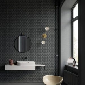 Tile Samples 37 Modern bathroom with black hexagon tile wall, circular mirror, contemporary sink, and stylish lighting, showcasing high-quality bathroom fixtures and accessories from Builders Warehouse Online.