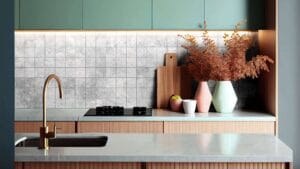 Vibrant modern kitchen with sage green cabinets, white marble countertop, and decorative vases with dried foliage for stylish home renovation interior decor.