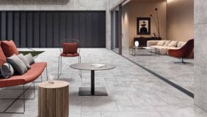 Modern outdoor patio furniture with a sleek black coffee table, rust-colored seating, and plush cushions, perfect for stylish backyard entertainment and relaxation.