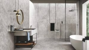 Sleek modern bathroom with grey tiles, minimalist vanity, chrome fixtures, walk-in shower, and a freestanding bathtub, designed for contemporary home renovation and stylish bathroom upgrades.