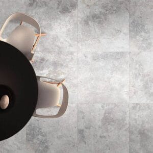 Gray concrete tile flooring in modern kitchen, minimalistic design with round black dining table, contemporary furniture, interior decor, home renovation, building supplies from Builders Warehouse Online.