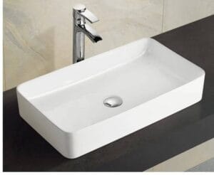 Ceramic bathroom sink with modern design and chrome faucet for home renovation or remodeling.