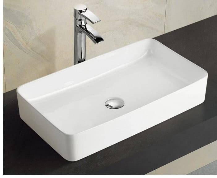 Ceramic bathroom sink with modern design and chrome faucet for home renovation or remodeling.