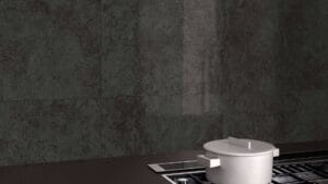 Sleek black textured wall tiles in a modern kitchen setting with a stainless steel pot on the stove. Perfect for contemporary kitchen renovations and durable wall tiling solutions.