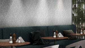 Textured white hexagon tile wall in modern restaurant interior.