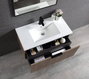 White modern bathroom vanity with sink, black faucet, and open storage drawer, ideal for contemporary home or bathroom renovation projects.