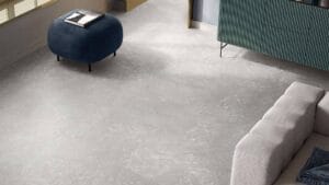 Polished marble-look flooring in modern living room, neutral gray shades, sleek design, stylish interior decor, high-quality tile, durable surface for residential spaces, contemporary home decor.