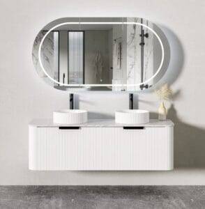 Modern bathroom vanity with double vessel sinks and a large oval illuminated mirror, showcasing stylish fixtures and contemporary decor.