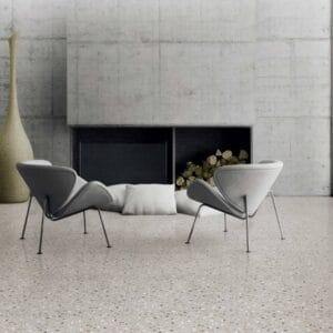 Modern minimalist living room with contemporary lounge chairs and a sleek concrete fireplace. Stylish home decor with neutral tones and clean lines, perfect for modern interior design.