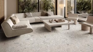 Sleek modern living room with neutral-toned furniture, large windows, and terrazzo flooring, showcasing stylish home interior design elements from Builders Warehouse Online.