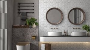 Modern bathroom with double vessel sinks, hex tile wall, round wooden mirrors, indoor plants, and sleek fixtures, showcasing contemporary design and bathroom renovation ideas.