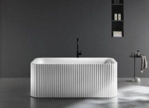 Buying Guide for Freestanding Baths 1 Contemporary white freestanding bathtub with ribbed exterior texture, modern black faucet, and minimalist decor in a sleek bathroom setting.