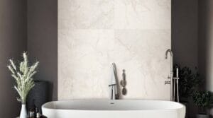 The Ultimate Bathroom Renovation Planning Guide 2 Modern freestanding bathtub with chrome fixtures in a stylish bathroom featuring a marble wall background. Perfect for a luxurious home renovation or bathroom remodeling project.