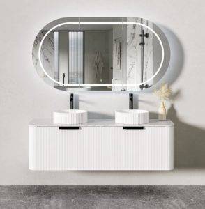 Modern bathroom vanity with oval LED mirror, double vessel sinks, and minimalist decor. Perfect for contemporary home renovations and stylish bathroom upgrades.