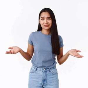 Confused woman shrugging with raised hands, symbolizing uncertainty, for home improvement or DIY questions about building supplies from Builders Warehouse Online.