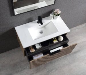 White bathroom vanity with sink, black faucet, and storage drawers, modern bathroom furniture, home renovation, bathroom accessories, Builder's Warehouse Online.