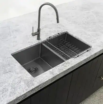 Modern black kitchen sink with dual basin and chrome tap.